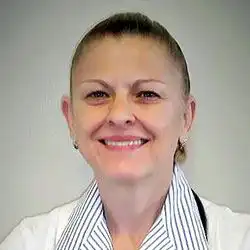Professional headshot of a healthcare provider wearing a white clinical coat